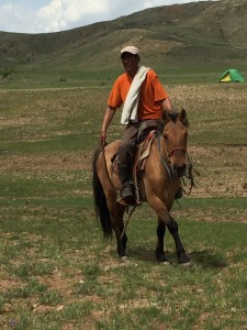 Local rider passing through camp