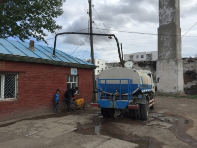 Many houses don't have running water so resident use small trolleys and plastic containers to collect water from a central water point.