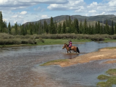 Couple of young lads on horseback crossing the river below camp...