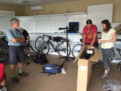 Packing Liz's bike (Mike another rider at left, Jordan our tour mechanic, and Liz)