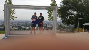 Michael, myself, kiwi flag, the finger of our photographer, and Almaty in the background)