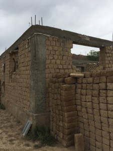 Another shot showing how a concrete frame is used to support the upper story and/or roof in a mud-brick house