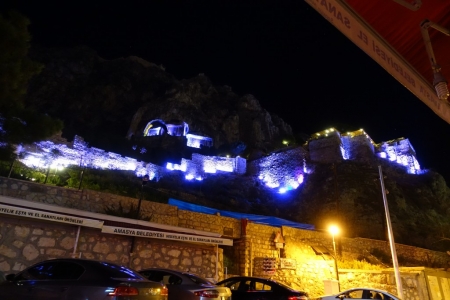Castle and tombs above town all lit up